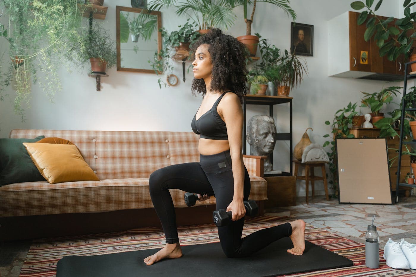 African woman doing a home strength workout