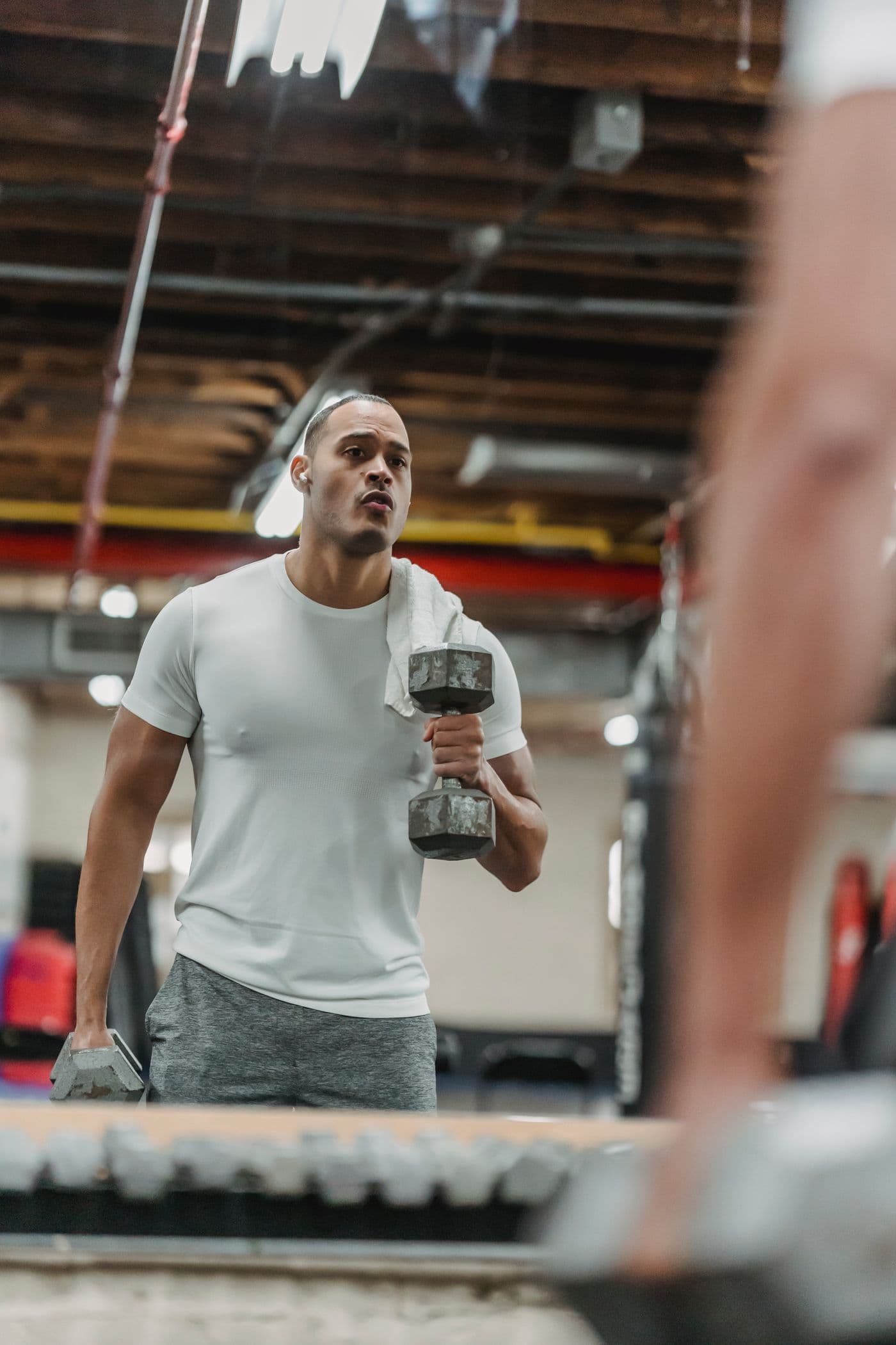 Confident man training with dumbbells